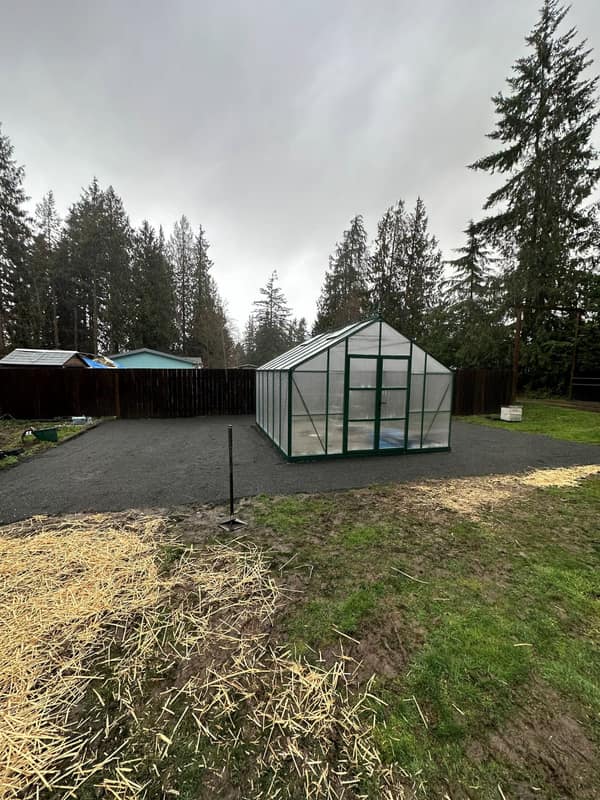 Compacted gravel pad foundation with a residential greenhouse set on top — Peninsula site work