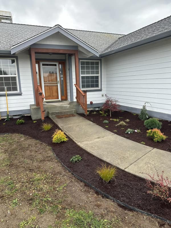 Sequim, WA front yard landscape refresh with fresh beds, mulch, and a new walkway