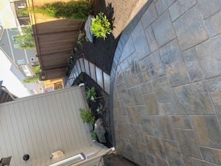 Dark slate paver patio — full side-yard scene with mature plantings